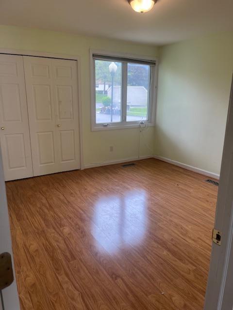 40 Jefferson Oval Unit A, Yorktown Heights, NY 10598 - unfurnished bedroom with wood finished floors, baseboards, and a closet