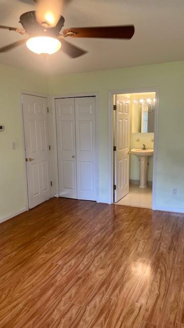 40 Jefferson Oval Unit A, Yorktown Heights, NY 10598 - unfurnished bedroom with wood finished floors, a closet, a sink, and baseboards