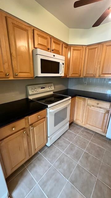 40 Jefferson Oval Unit A, Yorktown Heights, NY 10598 - kitchen featuring white appliances, a ceiling fan, dark countertops, and tile patterned floors