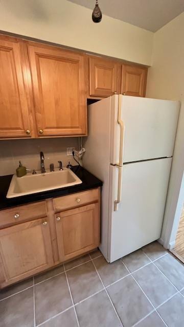 40 Jefferson Oval Unit A, Yorktown Heights, NY 10598 - kitchen featuring a sink, freestanding refrigerator, light tile patterned flooring, and dark countertops