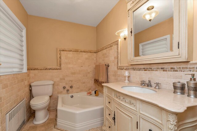 bathroom with a bath, toilet, tile walls, radiator, and vanity