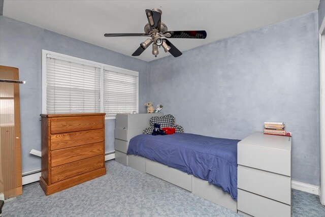 bedroom featuring a baseboard heating unit, carpet floors, and ceiling fan