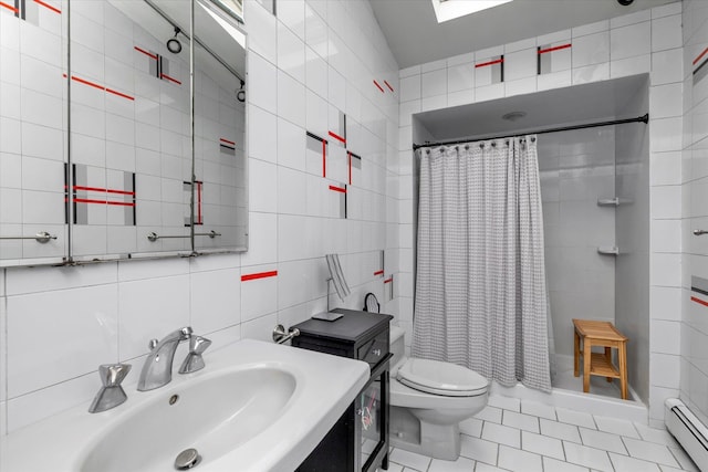 bathroom with baseboard heating, a sink, tile walls, a shower with curtain, and tile patterned flooring