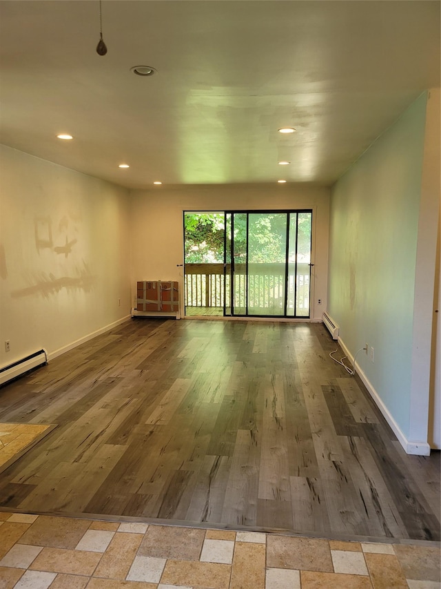 23 Hillside Ter Unit H, White Plains, NY 10601 - empty room featuring a baseboard heating unit, baseboards, and wood finished floors
