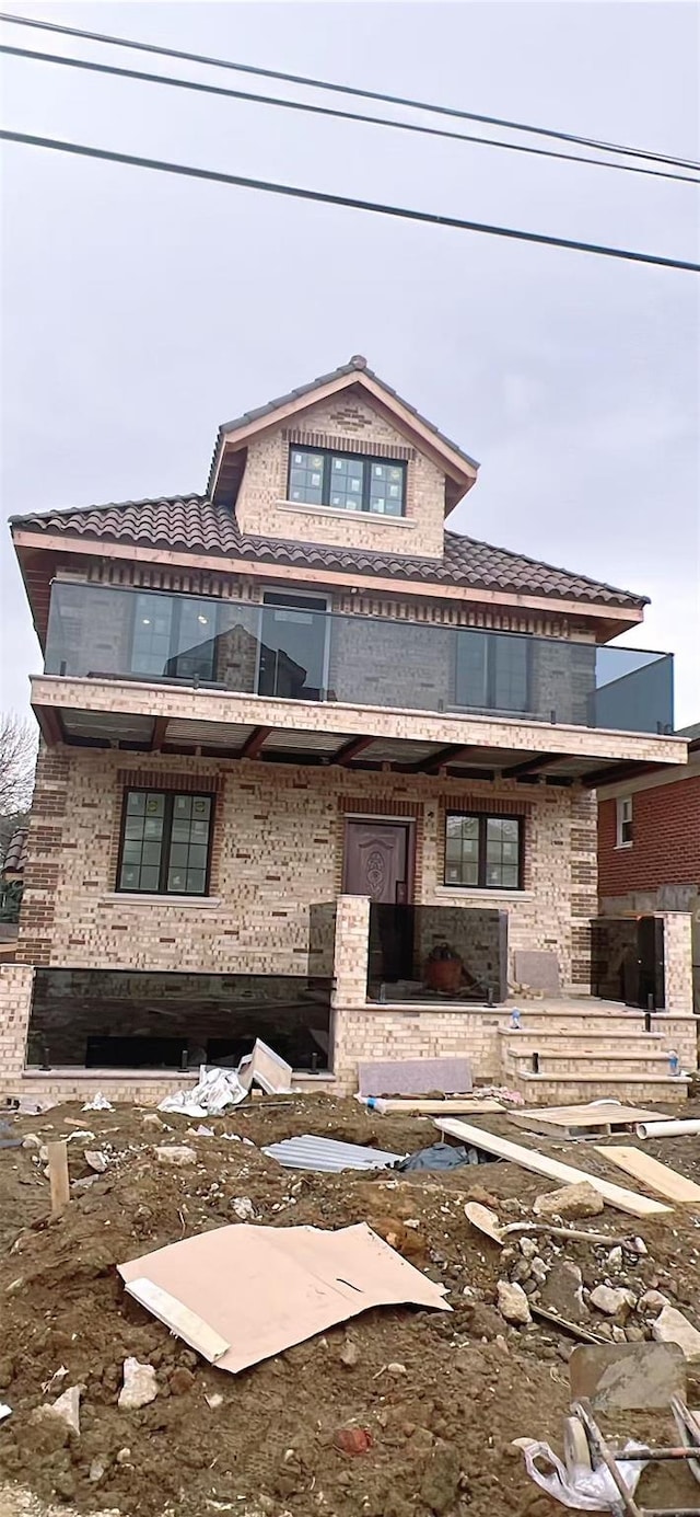 view of front of home featuring brick siding