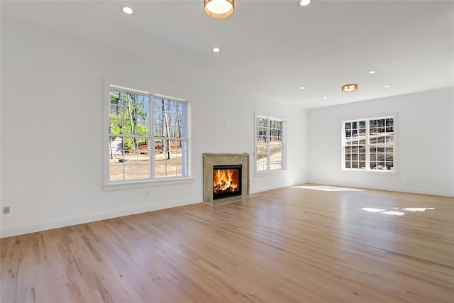 unfurnished living room with recessed lighting and plenty of natural light
