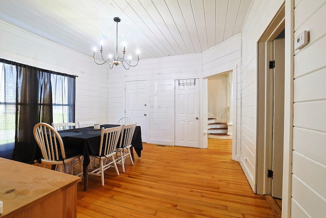 dining area featuring wood ceiling, an inviting chandelier, light wood finished floors, and stairway
