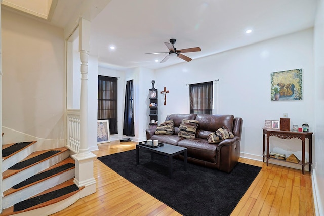 living room featuring recessed lighting, light wood-type flooring, baseboards, stairs, and ceiling fan