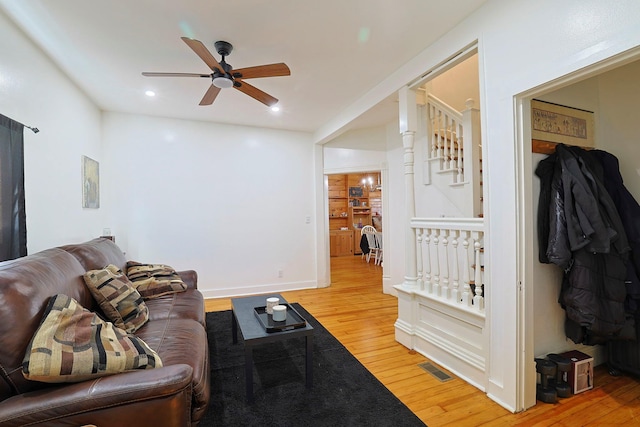 living room featuring stairway, a ceiling fan, light wood-style floors, visible vents, and recessed lighting