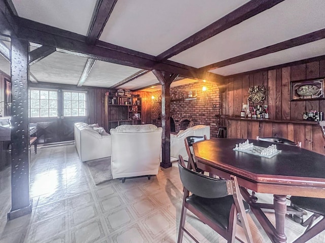 14 Scott St, Dix Hills, NY 11746 - dining room with tile patterned floors, wooden walls, beam ceiling, and a fireplace