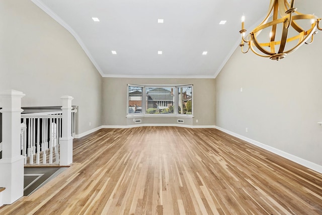 unfurnished living room with baseboards, an inviting chandelier, ornamental molding, and light wood-type flooring
