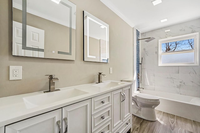bathroom with shower / bath combination, toilet, a sink, and double vanity