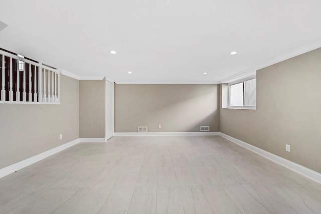 below grade area featuring baseboards, ornamental molding, visible vents, and recessed lighting