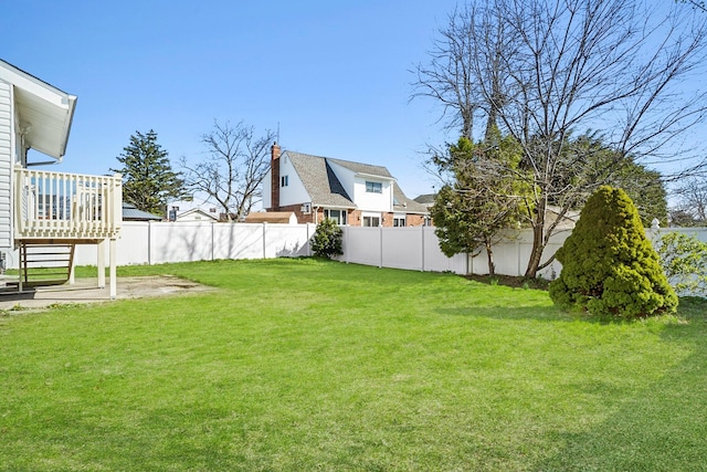 view of yard featuring a fenced backyard and a deck