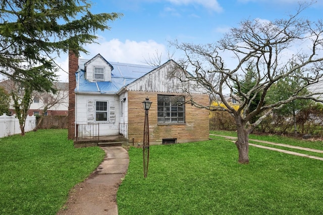 29 Seaman Ave, Rockville Centre, NY 11570 - view of front facade with fence, a front lawn, and a chimney