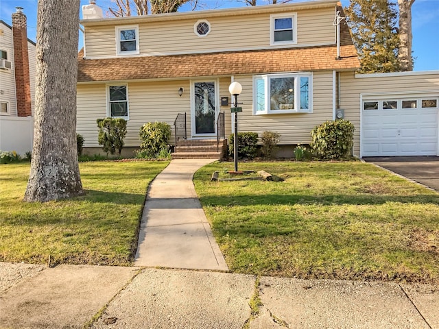 view of front facade featuring a shingled roof, entry steps, a front yard, and a garage