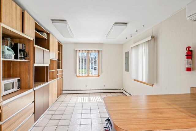 interior space featuring baseboard heating, an AC wall unit, electric panel, and light tile patterned floors