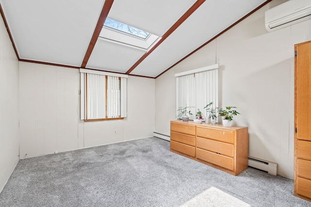 carpeted bedroom featuring a wall mounted air conditioner, a baseboard heating unit, and vaulted ceiling with skylight