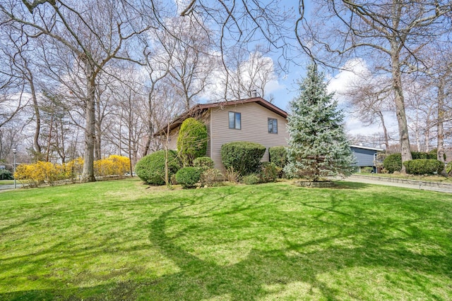 view of property exterior with a yard