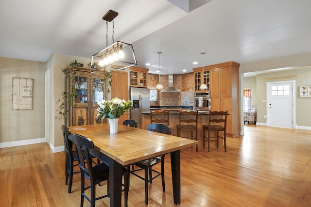 dining area featuring recessed lighting, light wood-style floors, and baseboards