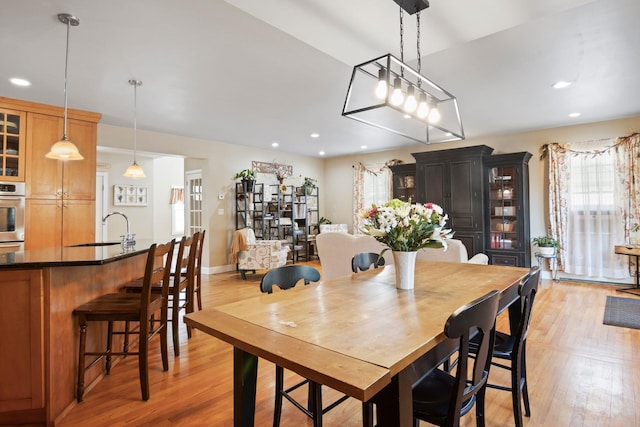 dining space with recessed lighting, plenty of natural light, and light wood finished floors
