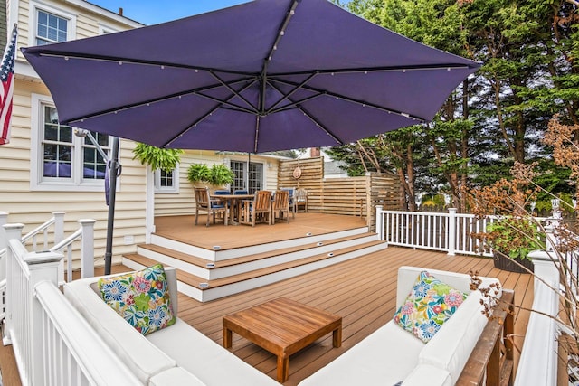 deck with an outdoor living space and outdoor dining area