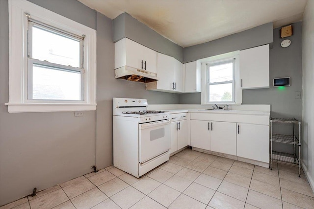 kitchen featuring white cabinets, a sink, light countertops, under cabinet range hood, and white gas range