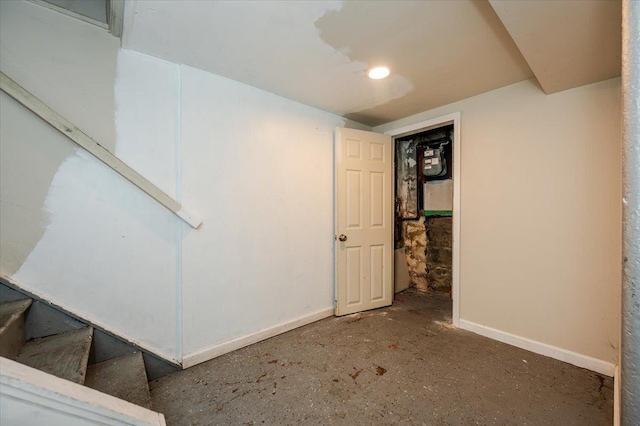 finished basement featuring baseboards and stairs