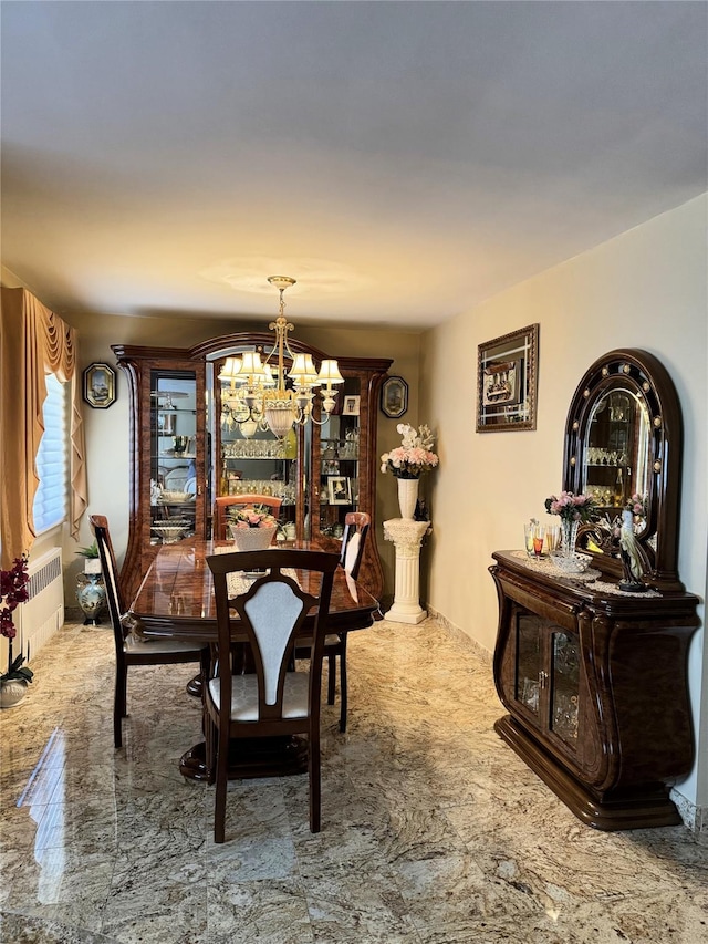 dining area featuring an inviting chandelier and radiator heating unit