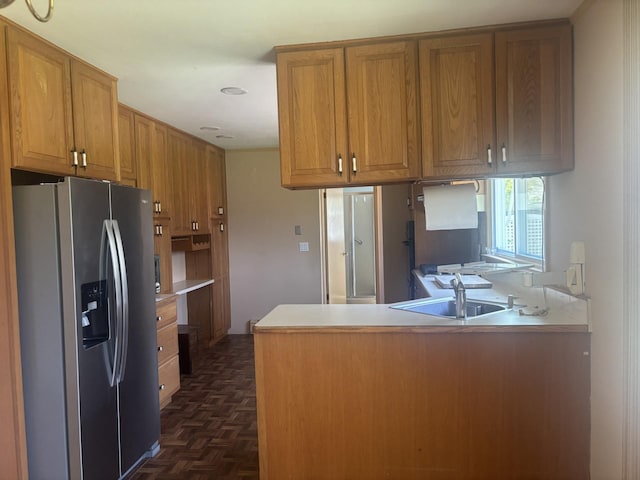 60 Hewitt Blvd, Center Moriches, NY 11934 - kitchen with brown cabinetry, stainless steel fridge with ice dispenser, light countertops, a sink, and a peninsula
