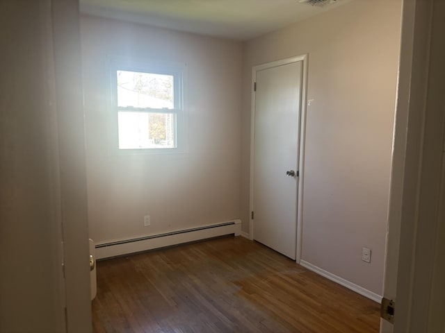 60 Hewitt Blvd, Center Moriches, NY 11934 - spare room with visible vents, baseboard heating, wood finished floors, and baseboards