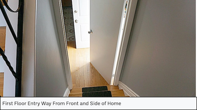 hallway with wood finished floors and baseboards