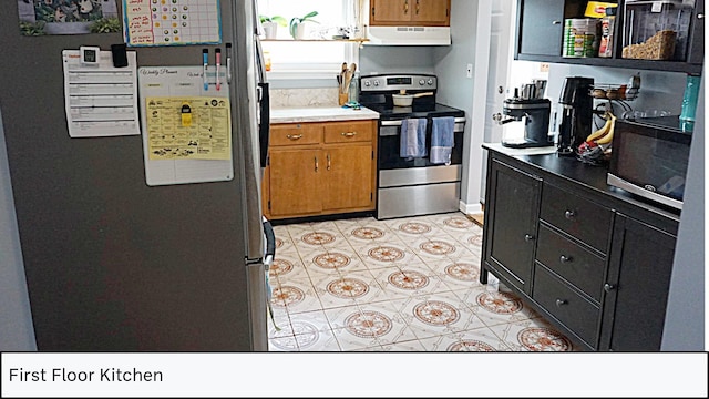 kitchen with light countertops, exhaust hood, brown cabinets, and appliances with stainless steel finishes