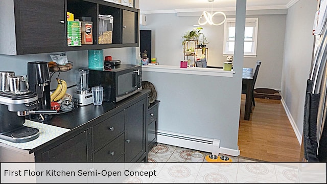 kitchen featuring a baseboard heating unit, black microwave, crown molding, and dark cabinets