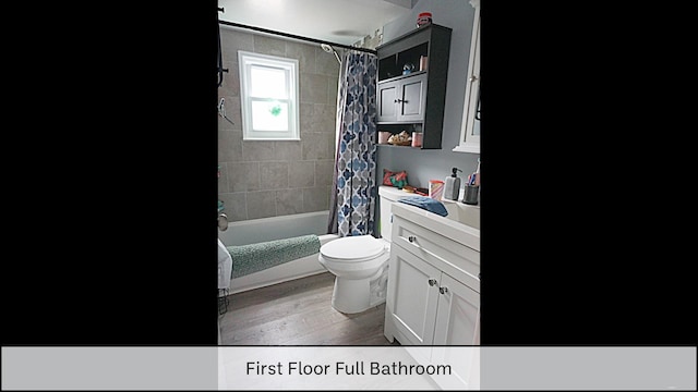 full bath featuring shower / tub combo, toilet, vanity, and wood finished floors