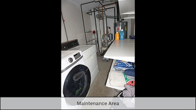 laundry room featuring washing machine and dryer, water heater, and laundry area
