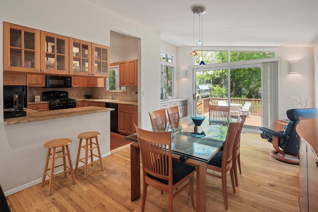 dining area with light wood-style floors