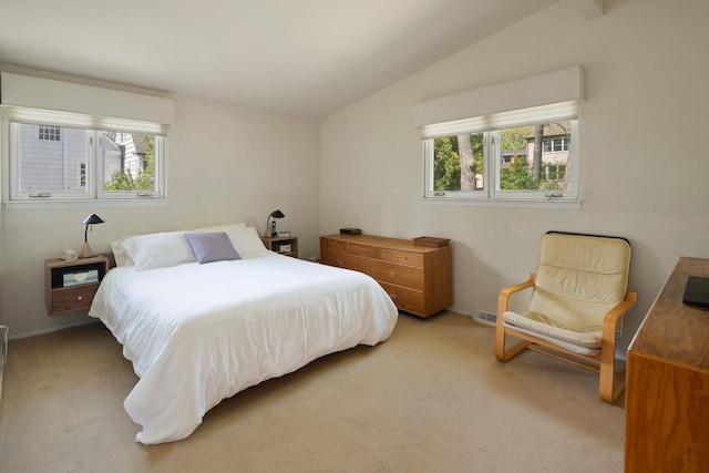 carpeted bedroom featuring vaulted ceiling and multiple windows