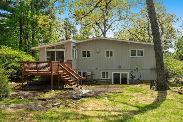rear view of house featuring a deck and stairway