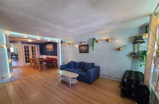 108 Main St, Livingston Manor, NY 12758 - living room featuring baseboard heating, a textured ceiling, french doors, and wood finished floors