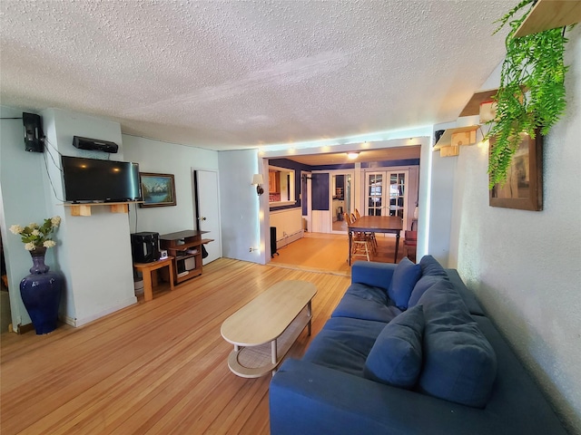 108 Main St, Livingston Manor, NY 12758 - living area featuring a textured ceiling, light wood-style floors, and baseboard heating