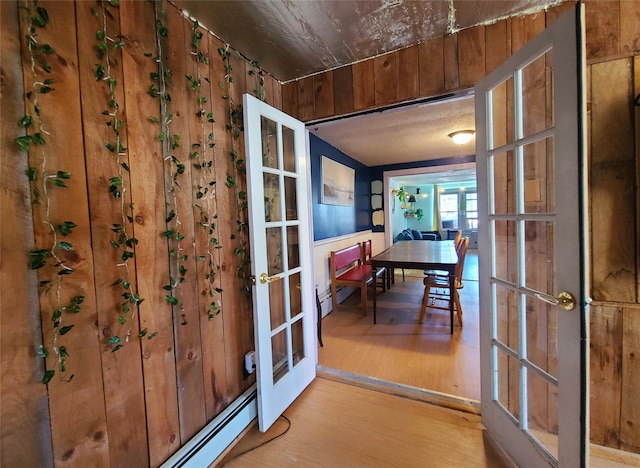 108 Main St, Livingston Manor, NY 12758 - doorway to outside featuring french doors, wood finished floors, and a baseboard radiator
