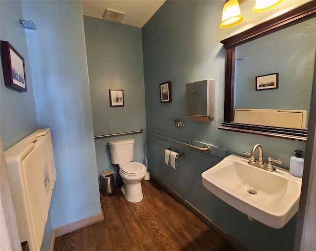 108 Main St, Livingston Manor, NY 12758 - bathroom featuring a sink, wood finished floors, toilet, and baseboards