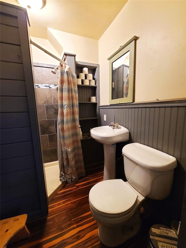 108 Main St, Livingston Manor, NY 12758 - full bathroom with wainscoting, wood finished floors, toilet, and a tile shower