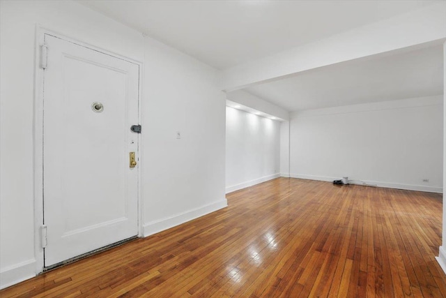 entrance foyer with hardwood / wood-style flooring and baseboards