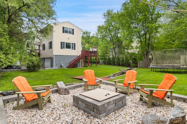 20 Brook St, Mount Kisco, NY 10549 - view of grassy yard with a fire pit, a trampoline, stairway, and a wooden deck