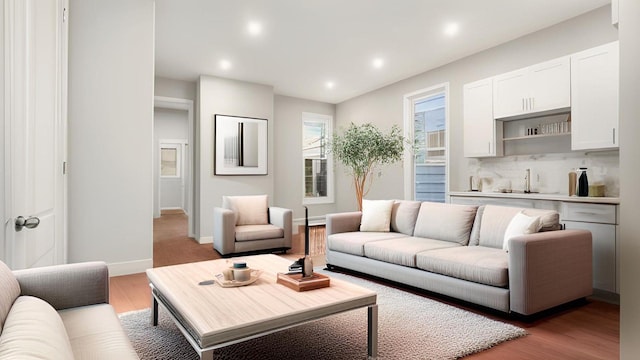 679 E 221st St, Bronx, NY 10467 - living area featuring recessed lighting, bar, wood finished floors, and baseboards