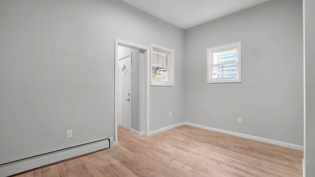 679 E 221st St, Bronx, NY 10467 - spare room with baseboard heating, light wood finished floors, and baseboards