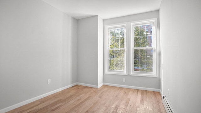 679 E 221st St, Bronx, NY 10467 - spare room with light wood-style flooring, a baseboard radiator, and baseboards