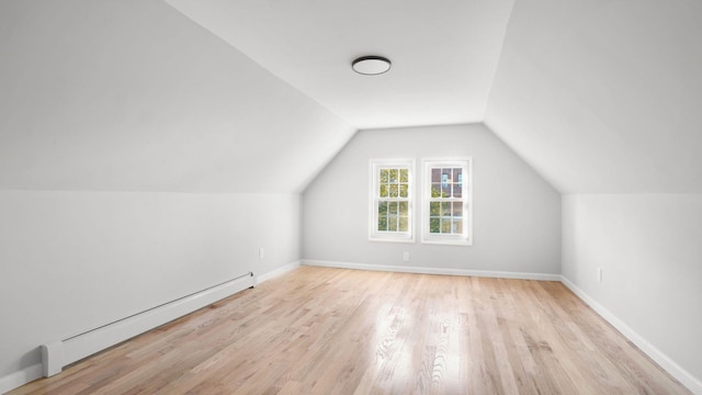 679 E 221st St, Bronx, NY 10467 - additional living space featuring a baseboard radiator, wood finished floors, lofted ceiling, and baseboards
